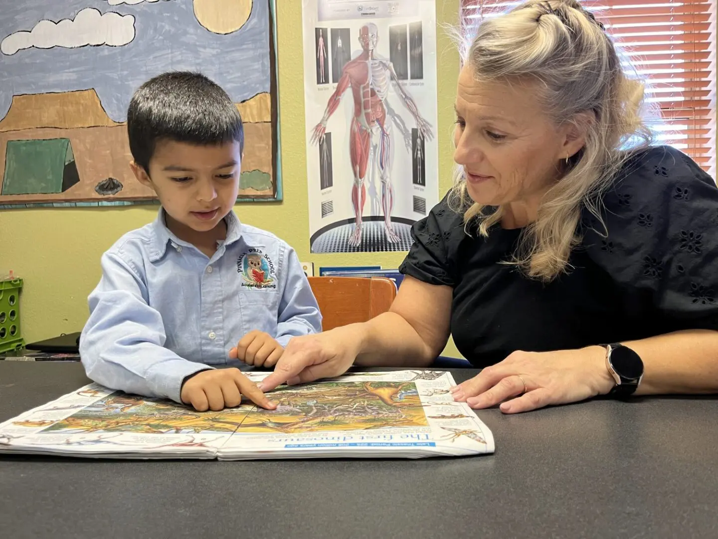 A woman and boy are playing with a puzzle