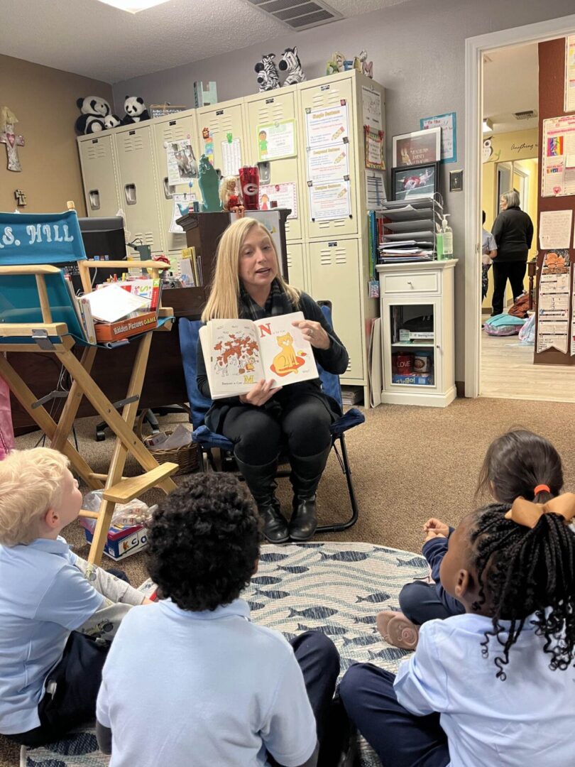 A woman reading to children in a classroom.